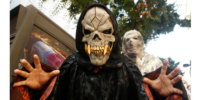 Costumed performers from an amusement park pose during a promotional event "Happy Halloween &amp; Horror Night" at the Myeongdong shopping district in Seoul September 5, 2011. The event was held to generate publicity for activities in Everland Amusement Park during the Halloween season from September 9 to October 31.   REUTERS/Truth Leem (SOUTH KOREA - Tags: SOCIETY)