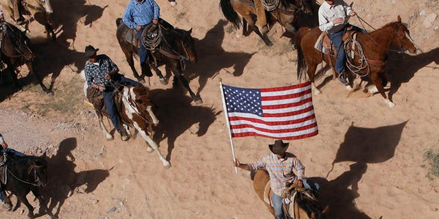 April 12, 2014: The Bundy family and their supporters fly the American flag as their cattle is released by the Bureau of Land Management.