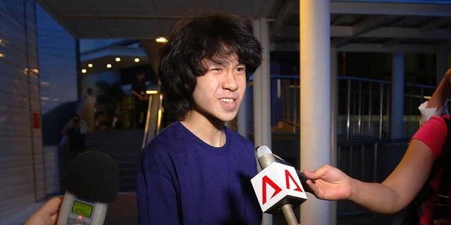 FILE - In this Tuesday, May, 12, 2015, file photo, Singapore teen blogger Amos Yee speaks to reporters while leaving the Subordinate Courts after being released on bail in Singapore. Yee whose video posts and blogs mocking his government and its late founder landed him in jail twice has been detained in the U.S. where he is seeking asylum. Human Rights Watch called on the U.S. to recognize Amos Yee’s asylum claim, saying he has been consistently harassed in Singapore for publicly expressing his views. (AP Photo/Wong Maye-E, File)