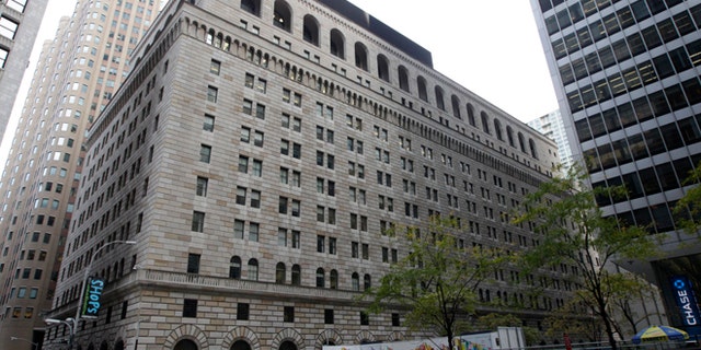 Oct. 17, 2012: Pedestrians pass the Federal Reserve Building in New York.