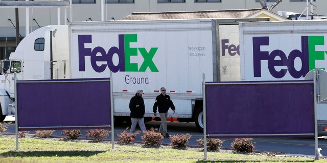 ATF agents investigate the scene at a FedEx distribution center where a package exploded, Tuesday, March 20, 2018, in Schertz, Texas.