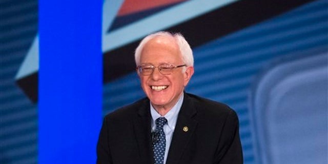 Democratic presidential candidate Sen. Bernie Sanders, I-Vt., smiles as he answers a question from the audience alongside host Anderson Cooper during a democratic primary town hall sponsored by CNN, Wednesday, Feb. 3, 2016, in Derry, N.H. (AP Photo/John Minchillo)