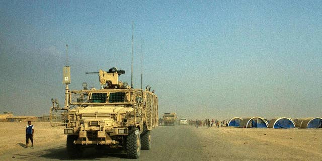 Armored coalition vehicles outside the Qayara air base in August.