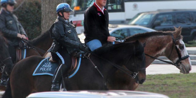 In this photo provided by the Interior Department shows Interior Secretary Ryan Zinke arriving for his first day of work at the Interior Department in Washington