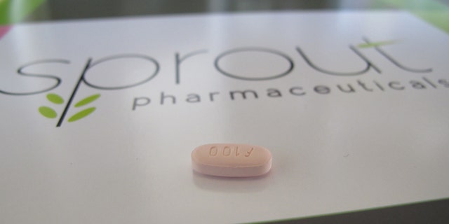 A tablet of flibanserin sits on a brochure for Sprout Pharmaceuticals in the company's Raleigh, N.C., headquarters. (AP Photo/Allen G. Breed)