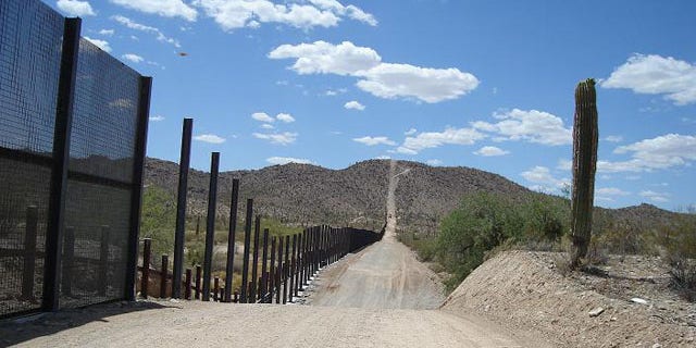 A pedestrian fence and a vehicle barrier are seen at Organ Pipe Cactus National Monument, near Lukeville, Ariz.