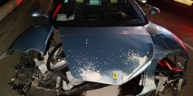 A huge chunk of a Ferrari appeared to be missing after an alleged drunken driver smashed it into a median.