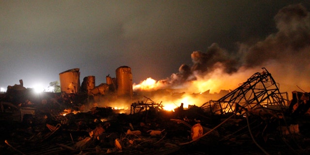 The remains of a fertilizer plant burn after an explosion at the plant in the town of West, near Waco, Texas early April 18, 2013. The deadly explosion ripped through the fertilizer plant late on Wednesday, injuring more than 100 people, leveling dozens of homes and damaging other buildings including a school and nursing home, authorities said.