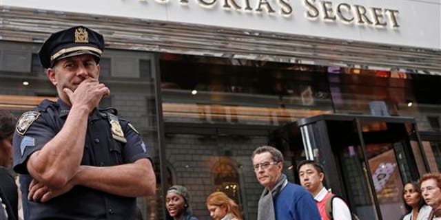 A New York City police officer stands in front of the Victoria's Secret Herald Square store in midtown Manhattan, Thursday, Oct. 17, 2013, in New York. A security guard on the lookout for shoplifters searched two teenage girls as they left the lingerie shop Thursday afternoon, and discovered one of them was carrying what appeared to be a fetus in her bag, police said. (AP Photo/Kathy Willens)
