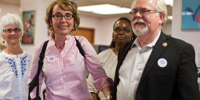 Nov. 5, 2012: Former congresswoman Gabrielle Giffords and Congressman Ron Barber leave the Pima County Recorder's office.