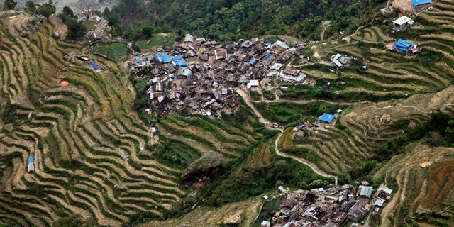 Destroyed villages sit on mountain tops near the epicenter of Saturday's massive earthquake, in the Gorkha District of Nepal, Wednesday, April 29, 2015. Aid reached a hilly district near the epicenter of Nepal's earthquake for the first time Wednesday, four days after the quake struck. (AP Photo/Wally Santana)