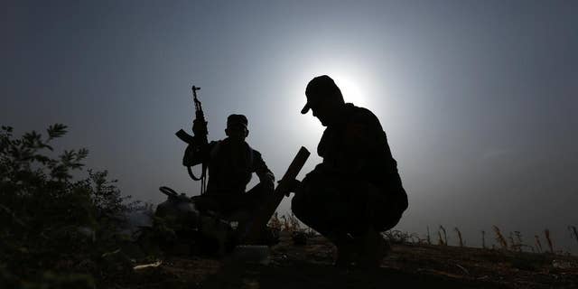 Oct. 1, 2014: Iraqi Kurdish soldiers pause from combat to make tea near to the front line in Mahmoudiyah, Iraq, a day after they take control of the village from the Islamic State group