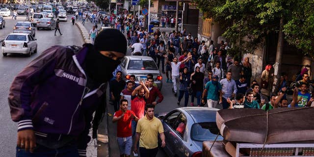 Egyptians demonstrate against President Abdel-Fattah el-Sissi in Mesaha square in Cairo's Dokki district, Monday, April 25, 2016. Police fired tear gas and birdshot on Monday to disperse hundreds of demonstrators calling on el-Sissi to step down over his government's decision to surrender control over two strategic Red Sea islands to Saudi Arabia. (AP Photo/Mostafa Darwish)