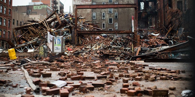A pile of debris remains at the site of a building explosion in the East Village neighborhood of New York, Friday, March 27, 2015. Nineteen people were injured, four critically, after the powerful blast and fire sent flames soaring and debris flying Thursday afternoon. Preliminary evidence suggested that a gas explosion amid plumbing and gas work inside the building was to blame. (AP Photo/The New York Times, Nancy Borowick, Pool)