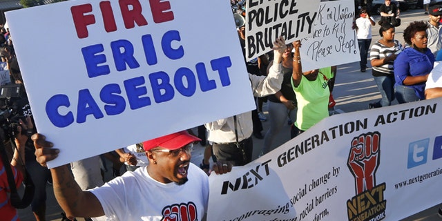Protestors march Monday, June 8, 2015, during a demonstration in response to an incident at a community pool involving McKinney police officers in McKinney, Texas. (AP Photo/Ron Jenkins)