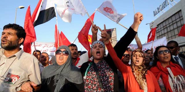 Tunisians march outside the National Assembly in Tunis on September 7, 2013.