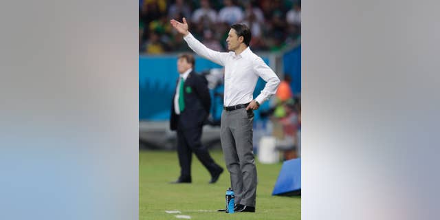 Croatia's coach Niko Kovac gestures during the group A World Cup soccer match between Croatia and Mexico at the Arena Pernambuco in Recife, Brazil, Monday, June 23, 2014. (AP Photo/Petr David Josek)