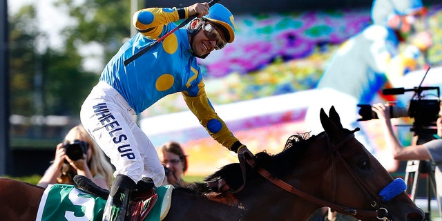 Victor Espinoza reacts after crossing the finish line with American Pharoah to win the 147th running of the Belmont Stakes horse race at Belmont Park, Saturday, June 6, 2015, in Elmont, N.Y. American Pharoah is the first horse to win the Triple Crown since Affirmed won it in 1978.  (AP Photo/Kathy Willens)