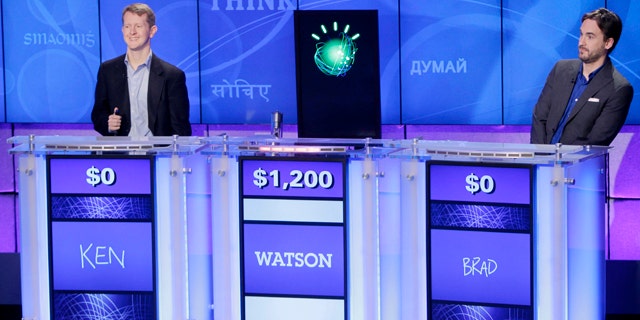 "Jeopardy!" champions Ken Jennings, left, and Brad Rutter, right, look on as an IBM computer called "Watson" beats them to the buzzer to answer a question during a practice round of the "Jeopardy!" quiz show in Yorktown Heights, N.Y., Thursday, Jan. 13, 2011.