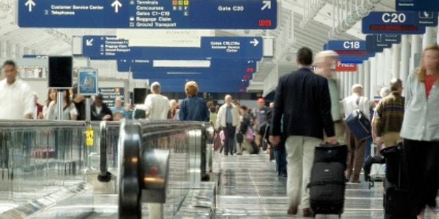 Travelers rushing through one of Chicago O'Hare airport terminals.