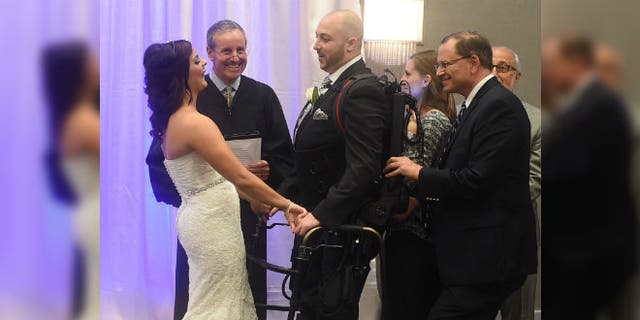 Jordan Basile, left, and Matt Ficarra, center, exchange wedding vows Saturday, Oct. 18, 2014, at the Doubletree hotel in Syracuse, N.Y. (AP Photo/The Syracuse Newspapers, Dennis Nett)