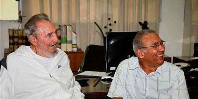 In this image released on Saturday July 10, 2010 by the state media Cubadebate website, Cuban leader Fidel Castro sits next to an unidentified man during a visit to the National Center for Scientific Investigation in Havana last July 7, 2010.