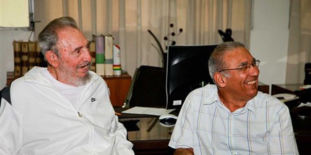 In this image released on Saturday July 10, 2010 by the state media Cubadebate website, Cuban leader Fidel Castro sits next to an unidentified man during a visit to the National Center for Scientific Investigation in Havana last July 7, 2010.