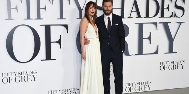 Feb. 12, 2015. Dakota Johnson and Jamie Dornan pose for photographers at the UK Premiere of "Fifty Shades of Grey."