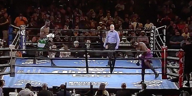 Curtis Harper, bottom right, walks out of the ring, seconds after touching gloves with Efe Ajagba.
