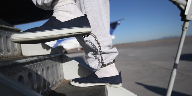MESA, AZ - FEBRUARY 28: A Honduran immigration detainee, his feet shackled as a security precaution, boards a deportation flight to San Pedro Sula, Honduras on February 28, 2013 in Mesa, Arizona. U.S. Immigration and Customs Enforcement (ICE), operates 4-5 flights per week from Mesa to Central America, deporting hundreds of undocumented immigrants detained in western states of the U.S. With the possibility of federal budget sequestration, ICE released 303 immigration detainees in the last week from detention centers throughout Arizona. More than 2,000 immigration detainees remain in ICE custody in the state. Most detainees typically remain in custody for several weeks before they are deported to their home country, while others remain for longer periods while their immigration cases work through the courts. (Photo by John Moore/Getty Images)