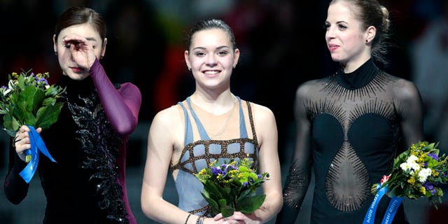 Feb. 20, 2014: Adelina Sotnikova of Russia, centre, Yuna Kim of South Korea, left, and Carolina Kostner of Italy stand on the podium during the flower ceremony for the women's free skate figure skating final at the Iceberg Skating Palace during the 2014 Winter Olympics in Sochi, Russia. Sotnikova placed first, followed by Kim and Kostner.