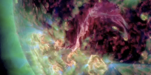 A pinkish-purple filament of hot plasma connects two sunspots in this ultraviolet view recorded by NASA's Solar Dynamics Observatory spacecraft on Aug. 4, 2012.