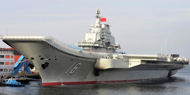 FILE - In this undated file photo released by China's Xinhua News Agency, China's aircraft carrier Liaoning berths in a port of China.