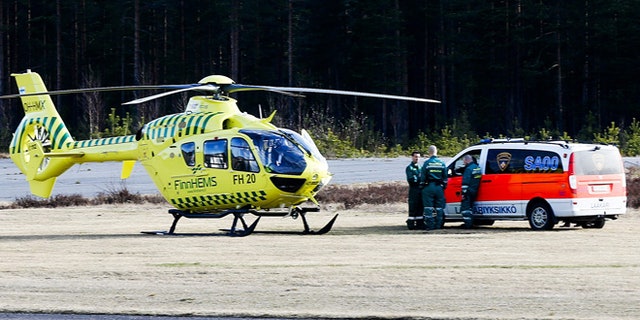 April 20, 2014: A helicopter and an ambulance are seen at the Jamijarvi Airfield, southwest Finland. A small passenger plane carrying parachuters fell to the ground near the airfield on Sunday afternoon. The police say that there are more than three victims. Three people out of 11 on the plane were rescued.