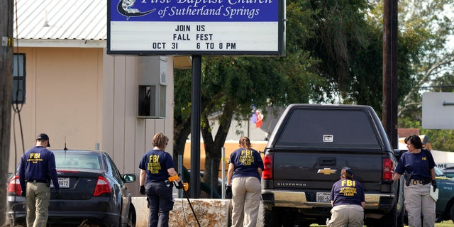 Members of the FBI Evidence Response Team use metal detectors outside the site of the shooting at the First Baptist Church of Sutherland, Texas, U.S., November 6, 2017. REUTERS/Rick Wilking - RC15DC1B1320