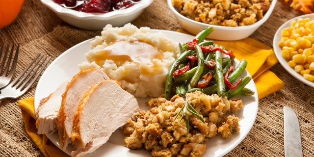 Cranberry sauce is commonly served with turkey, stuffing and vegetables on Thanksgiving.