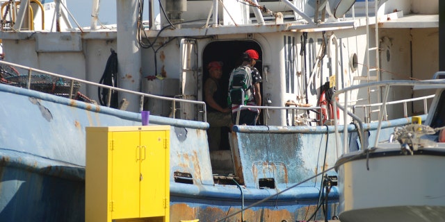 In this Sept. 14, 2016 file photo, fishermen stand on a boat at Pier 38 in Honolulu. A group of Hawaii lawmakers is holding a public meeting to discuss conditions among the Hawaii longline fleet.