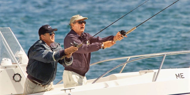 Former Presidents George Bush and George H.W. Bush go on a fishing outing near Kennebunkport, Maine, where the elder Bush resides part time.