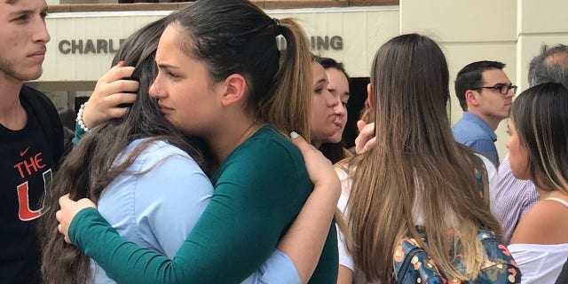 Friends of Alexa Duran, the 18-year-old FIU freshman killed in the collapse, comfort one another during the moment of silence on day when most students return to school after spring break. (Fox News)