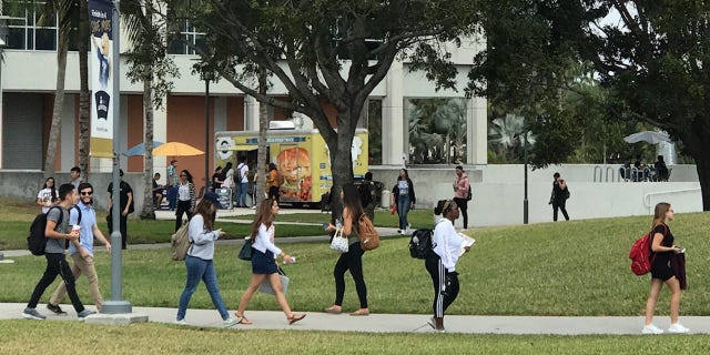 Students walk to class on their first day back from spring break, facing the aftermath of Thursday’s tragic bridge collapse.