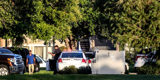Police continue to work at the scene of a hostage standoff where a police officer was shot.