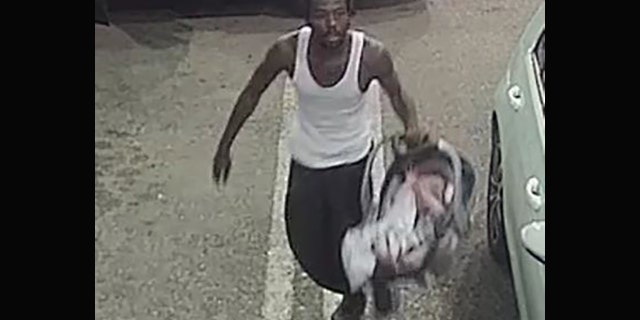 A man suspected of stealing a car at a Florida gas station with an infant inside Tuesday handed the baby to a clerk before taking off, police said.