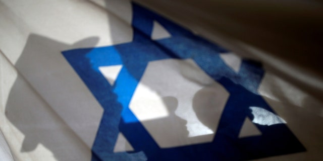 File photo - Israelis carry flags during a march marking Jerusalem Day, the anniversary of Israel's capture of East Jerusalem during the 1967 Middle East war, near Damascus Gate outside Jerusalem's Old City June 5, 2016. (REUTERS/Amir Cohen)