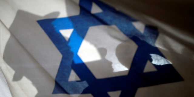 File photo - Israelis carry flags during a march marking Jerusalem Day, the anniversary of Israel's capture of East Jerusalem during the 1967 Middle East war, near Damascus Gate outside Jerusalem's Old City June 5, 2016. (REUTERS/Amir Cohen)