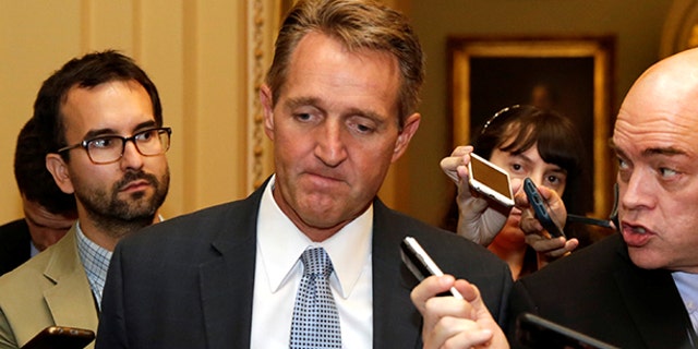 Senator Jeff Flake (R-AZ) talks to reporters as he arrives for a Senate health care vote on Capitol Hill in Washington, U.S., July 27, 2017. REUTERS/Yuri Gripas - RTX3D760