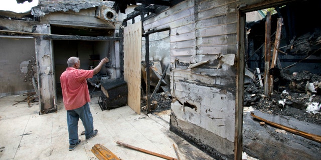 Sept. 15, 2016: Farhad Khan, who has attended the Islamic Center of Fort Pierce for more than seven years, shows members of the media its charred remains, in Fort Pierce, Fla.