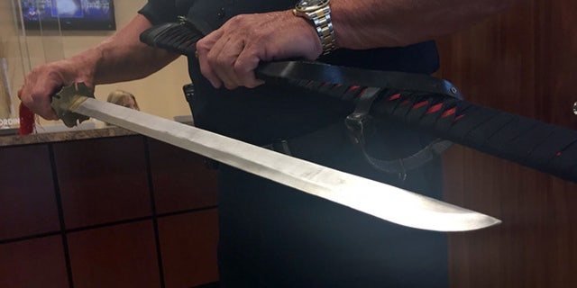 Police display the sword they say Daniel Seymour took out of his car during a road rage incident.