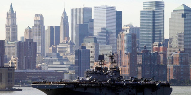 May 26, 2010: Sailors line the deck of the USS Iwo Jima as it passes the lower Manhattan skyline on arrival in New York Harbor for the start of Fleet Week. After a year's absence, Fleet Week is coming back to New York City. Three Navy ships and two Coast Guard cutters are scheduled to arrive in New York Harbor on Wednesday, May 21, 2014, the start of the week. (AP/Mark Lennihan, File)
