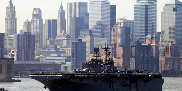 May 26, 2010: Sailors line the deck of the USS Iwo Jima as it passes the lower Manhattan skyline on arrival in New York Harbor for the start of Fleet Week. After a year's absence, Fleet Week is coming back to New York City. Three Navy ships and two Coast Guard cutters are scheduled to arrive in New York Harbor on Wednesday, May 21, 2014, the start of the week. (AP/Mark Lennihan, File)