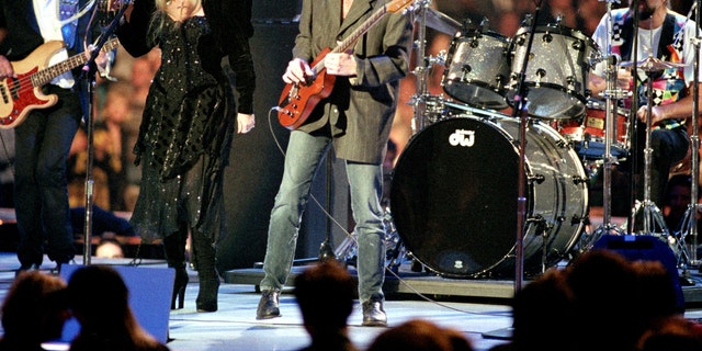 In a Monday, Jan. 18, 1993 file photo, the rock group Fleetwood Mac, reuniting after 13 years apart, performs during the American Gala evening at the Capital Centre in Landover, Md.   From left to right are, John McVie, Stevie Nicks, Lindsey Buckingham and Mick Fleetwood. Fleetwood Mac annunced Sunday, Oct. 27, 2013 that the group is canceling planned performances in Australia and New Zealand as bassist John McVie is treated for cancer.